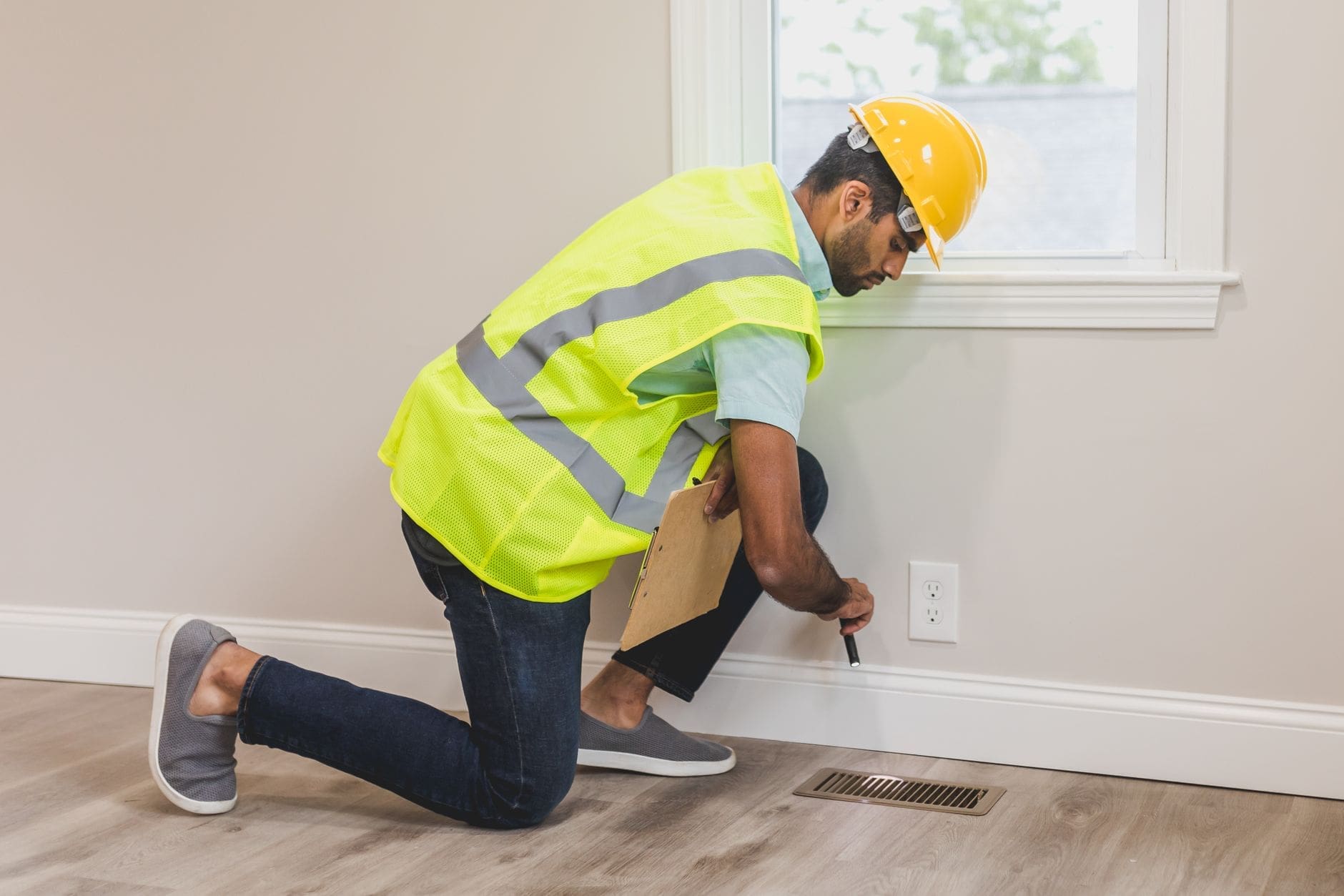 RICS surveyor conducting a home inspection, checking for damp with professional equipment